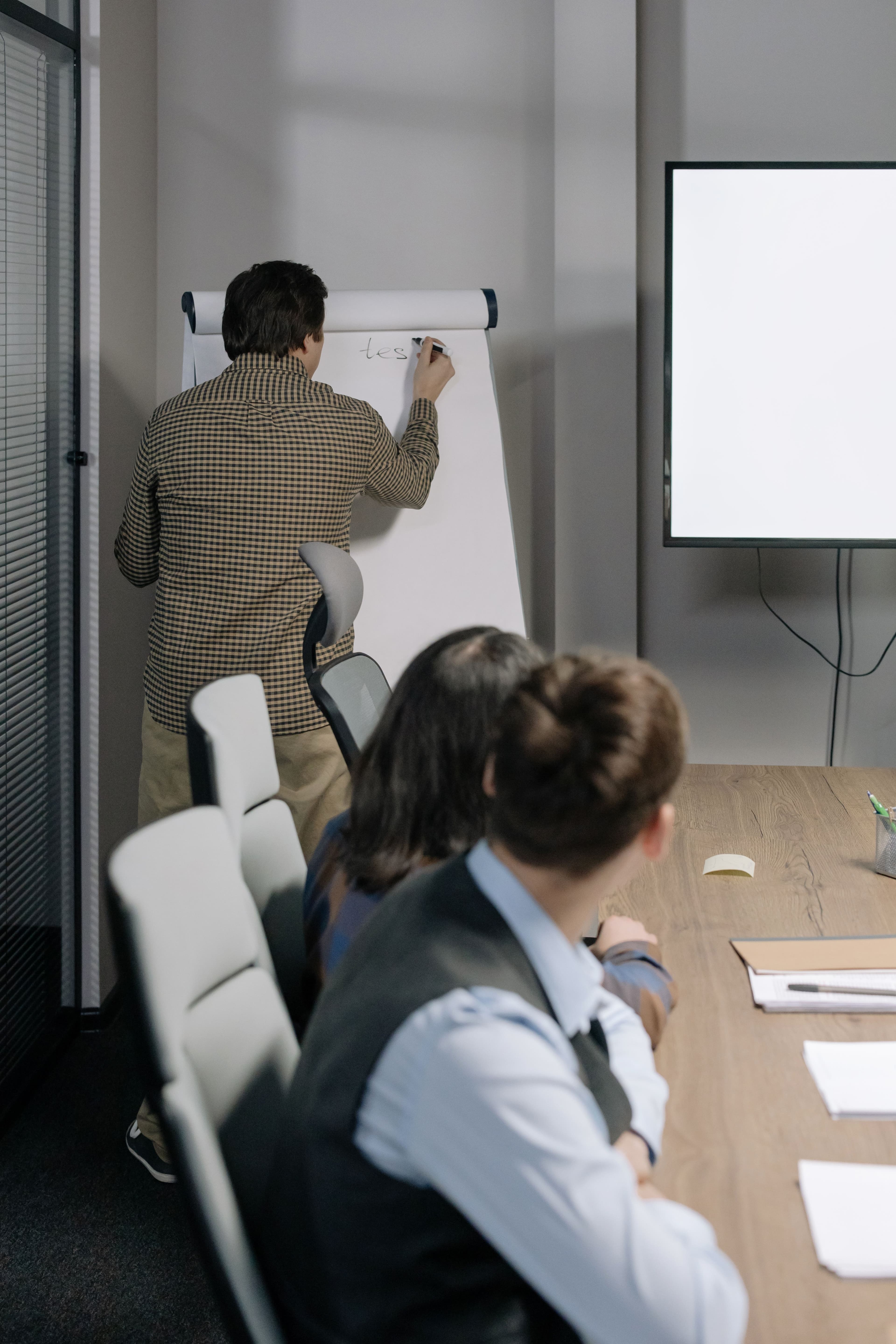 An instructor explaining concepts on a flip chart during a training session