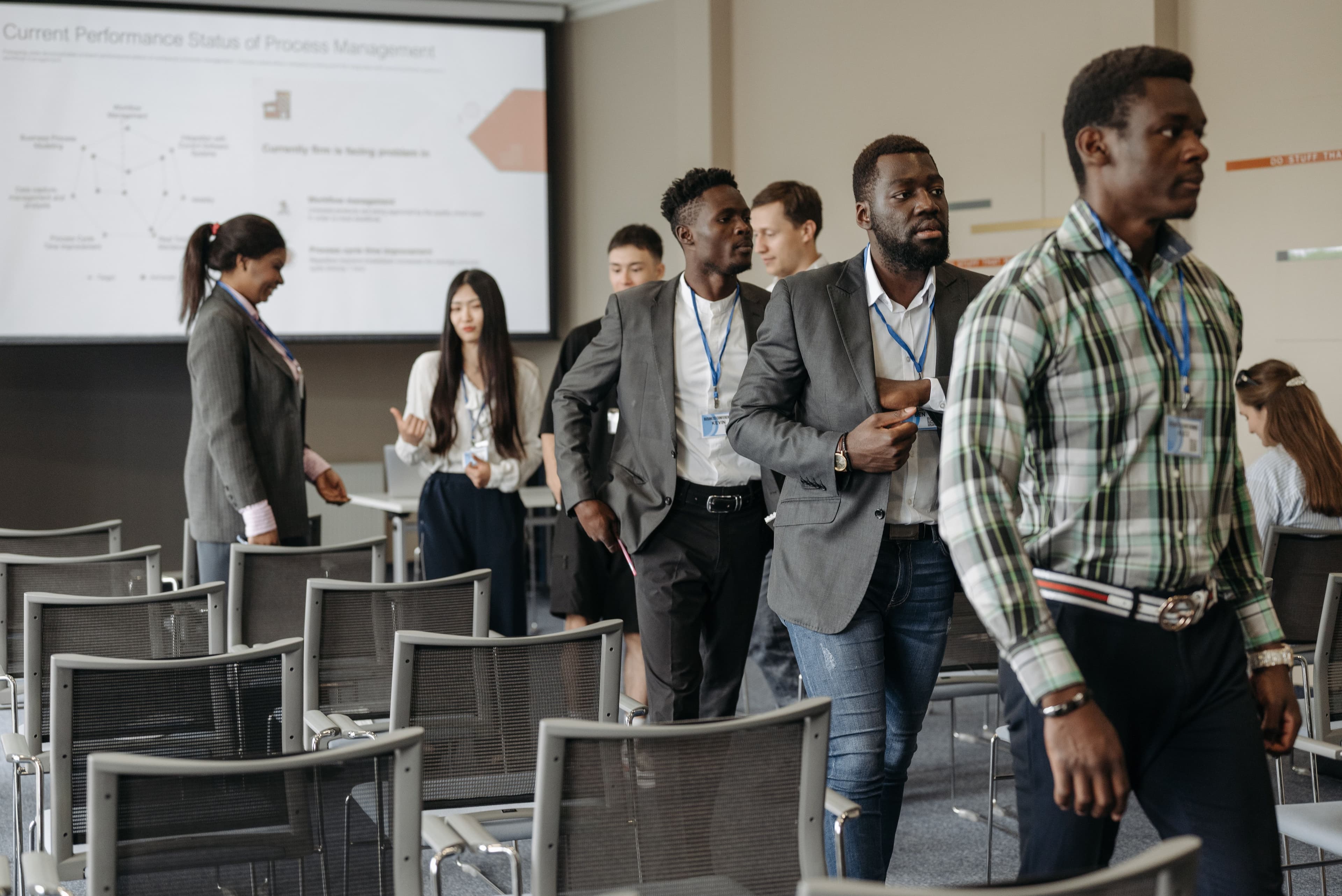 Attendees arriving for a corporate HR seminar in a conference hall