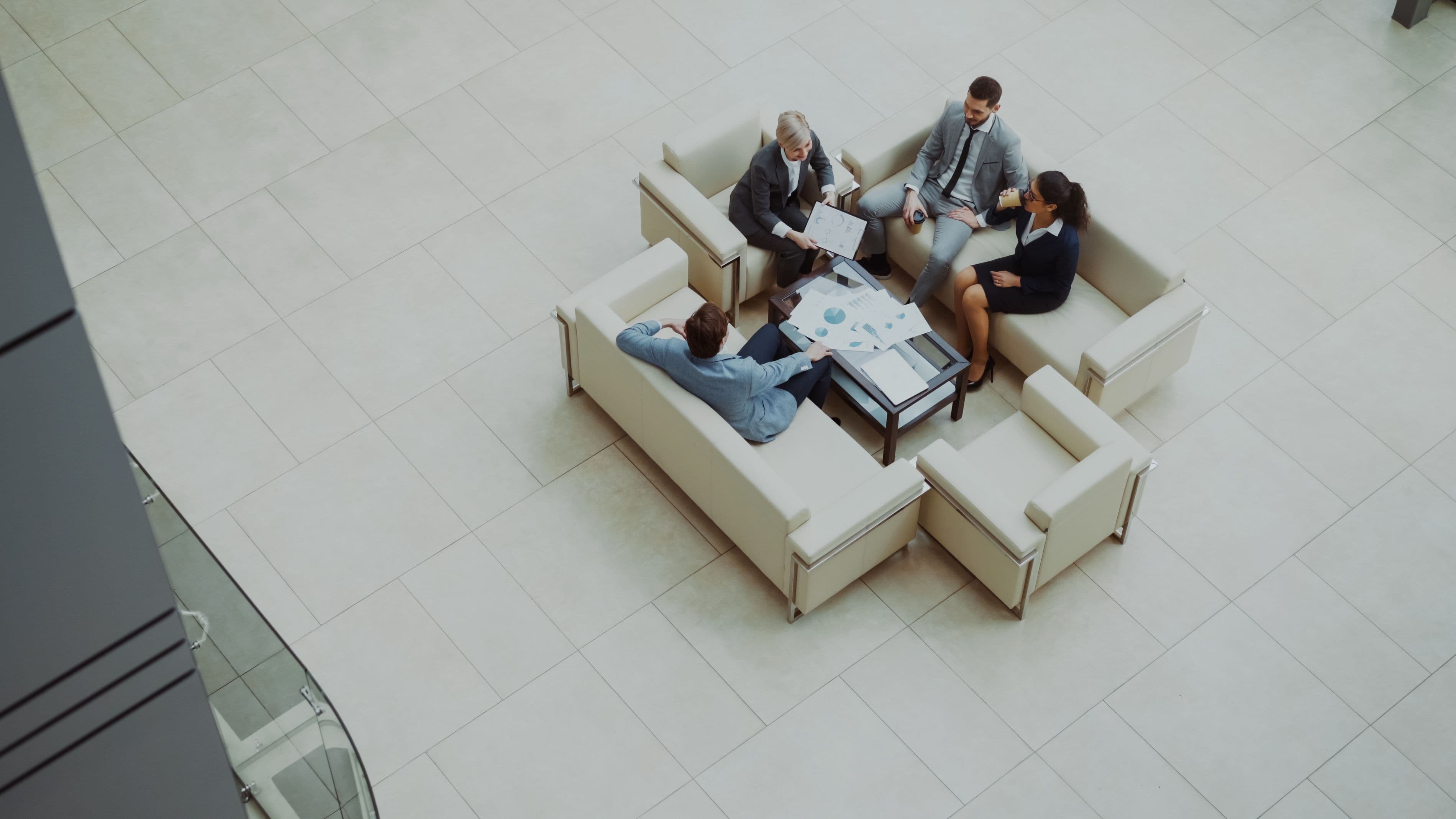 Overhead view of a business team meeting in a bright modern lounge